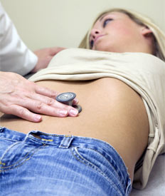 Doctor examining patient's abdomen